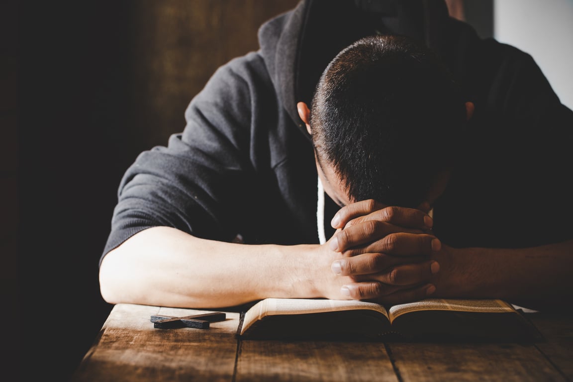 Religious Young Man Praying to God in the Morning